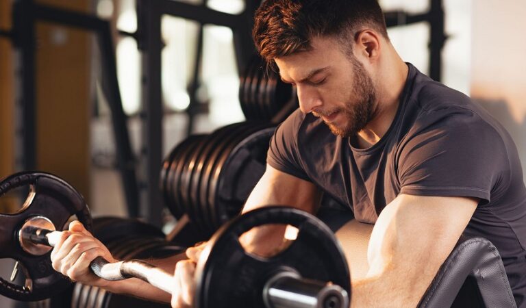 Exercise Addiction concept showing a man intensely lifting weights in a gym, highlighting excessive workout behavior and fitness obsession.