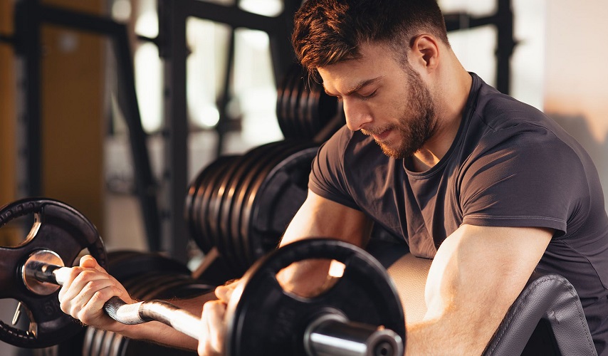 Exercise Addiction concept showing a man intensely lifting weights in a gym, highlighting excessive workout behavior and fitness obsession.