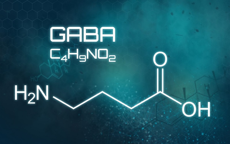 Chemical structure of the GABA neurotransmitter on a blue digital background, illustrating the connection between GABA and addiction.