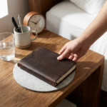 A person integrates healthy habits for a routine in addiction recovery by placing a journal on their bedside table each day.