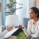 A woman discussing recovery progress with her therapist as part of the best residential rehab program.