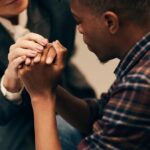 Compassionate counselor holding hands with a patient at an addiction treatment center Fort Wayne.