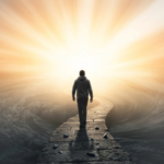 A person walks along a clear stone path away from stormy waters toward bright light, depicting recovery from a substance use disorder.