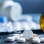 Prescription pills spilling out of a bottle, representing medication management during a structured benzodiazepine detox program.